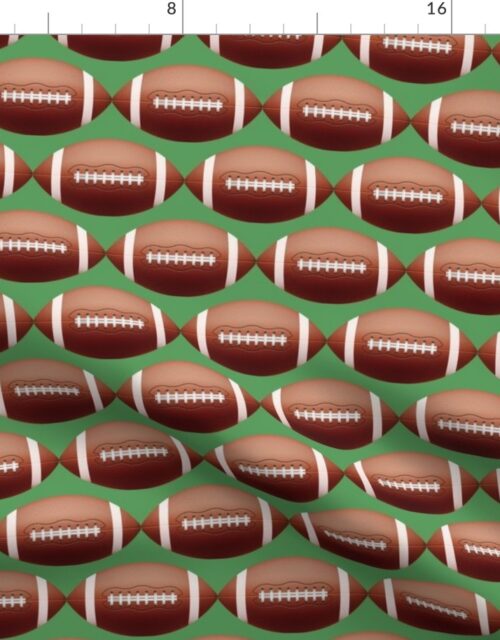 4 inch Gridiron American Pigskin Football with Lacing and Stitching on Field Green Fabric