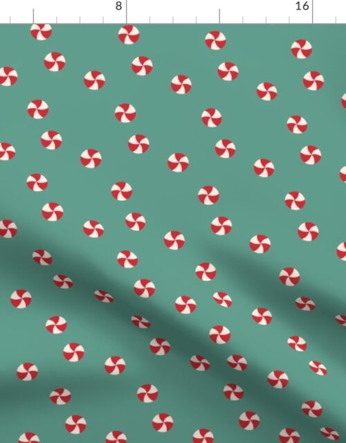 Peppermint Swirls in Red and White Scattered Randomly on on Green Fabric