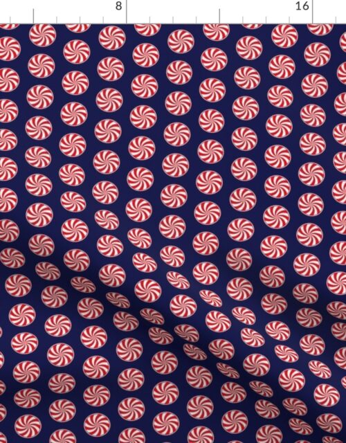 Red and White Peppermint Christmas Candy Swirls on Midnight Blue Fabric