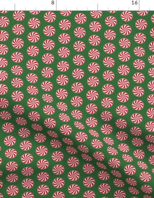 Red and White Peppermint Christmas Candy Swirls on Tree Green Fabric