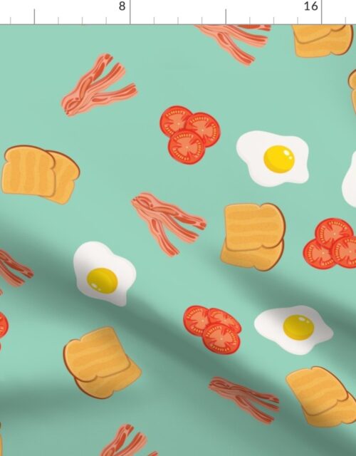 Small English Cooked Breakfast Bacon, Eggs, Tomato and Toast on Green Fabric